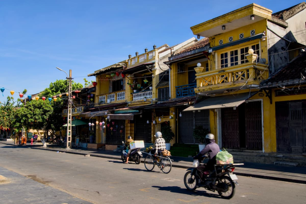Exploring Hoi An through everyday life in the Ancient Town as locals travel along its historic streets in Vietnam.