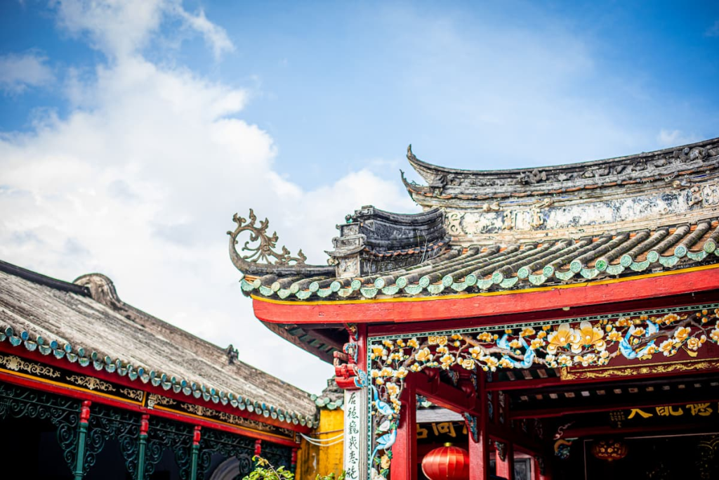 Exploring Hoi An through the ornate architecture and traditional rooflines of a historic Chinese assembly hall in Vietnam.