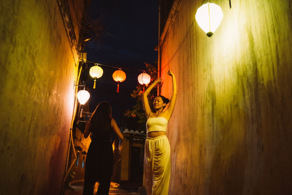 Exploring Hoi An through a lantern-lit laneway in the Ancient Town at night, Vietnam.