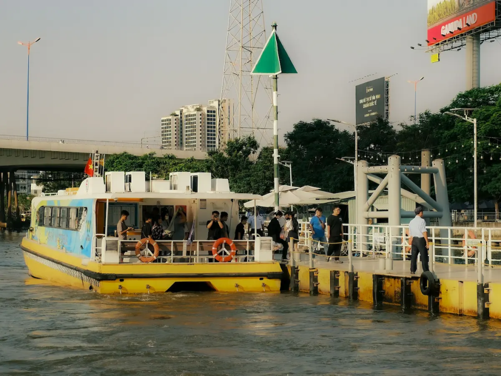 Travel journal inspiration showing a public ferry departing a riverside terminal as everyday commuters and travellers begin their journey.