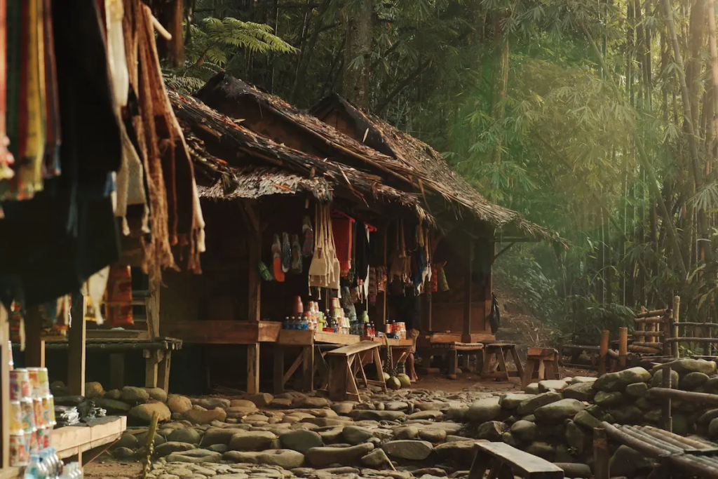 Travel photography capturing a traditional village surrounded by forest, illustrating authentic documentary storytelling through everyday life.